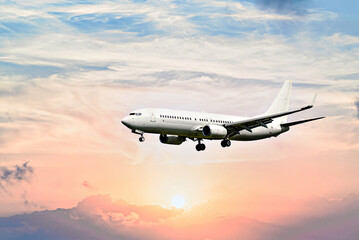 Private business jet flying under the sunset sky