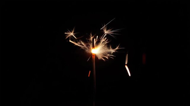 Igniting and burning a sparkling fuse firework against a dark background for celebration and festive occasions, Christmas and New Year
