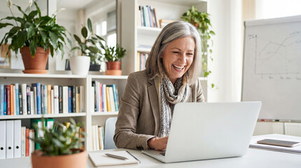 Happy mature business woman entrepreneur in office using laptop at work involving employee, manager, executive, job, middle, working, mature