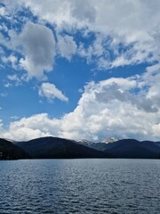 Mountain lake with dramatic clouds and pine forest