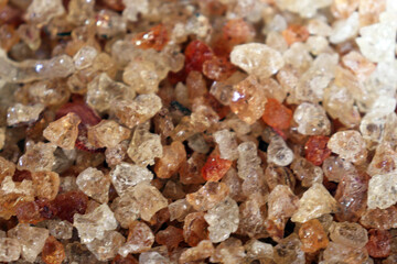 Close up of natural gum arabic resin granules with sparkling texture and golden color