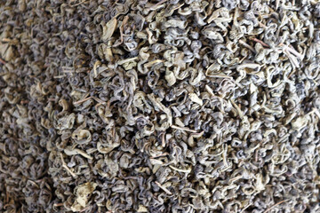Loose leaf green tea close up with curled leaves