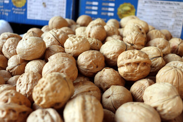 Walnuts close up showing whole nuts with ridged shells in retail display