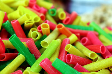 Fototapeta premium Colorful Tubular Fryums Snack Pile Close Up View
