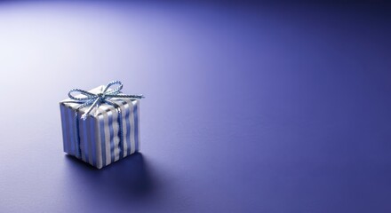 Small silver gift box with blue ribbon on purple background