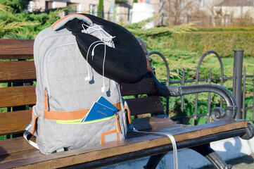 Backpack with Travel Essentials on Train Station Platform Bench
