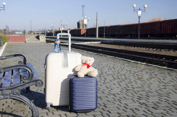 Suitcase and Travel Accessories on Empty Train Platform