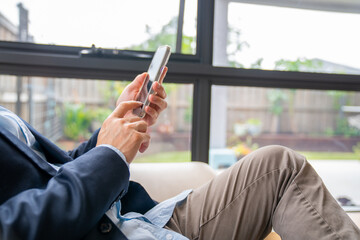 businessman using smartphone for business networking, holding mobile phone.