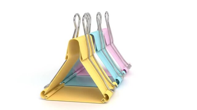 Pastel binder clips on white background.