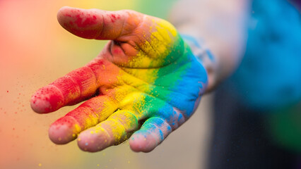 Open Hand Covered in Colorful Rainbow Powder Showing Inclusivity