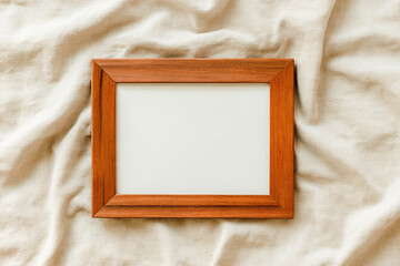 Blank wooden frame on soft fabric background for elegant interior mockup