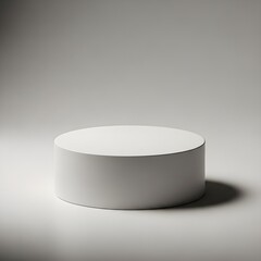 White round cylindrical pedestal in a minimalist studio setting for product presentation
