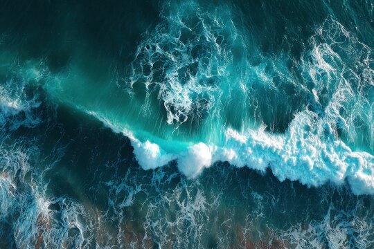 Aerial view of stormy ocean waves crashing in turquoise water