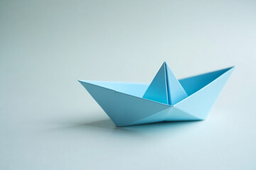 Blue Paper Boat: Simple Origami Craft on Light Background