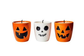 A festive display of three Halloween-themed candles featuring playful designs a grinning jack-o-lantern. a spooky skull. and a classic pumpkin. set against a clean white background