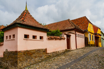 Cityscape. Old cobbled street with colorful buildings. Old town of Sighisoara, Transylvania, Romania