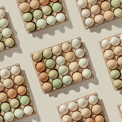Natural colored eggs in packaging, green brown white colorful Chicken egg, creative food pattern. Minimal Easter holiday, top view still life photo pastel color, flat lay with festive food