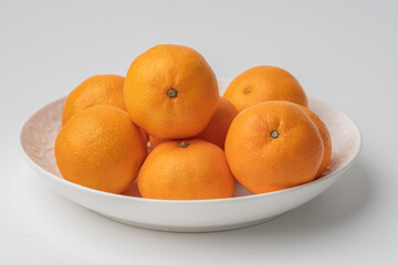 tangerines in a white plate