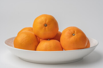 tangerines in a white plate