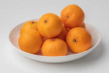 tangerines in a white plate