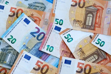 Euro money bills banknotes in big amount on table close up. Huge quantity of European Union currency cash on smooth surface. Business and rich life concept