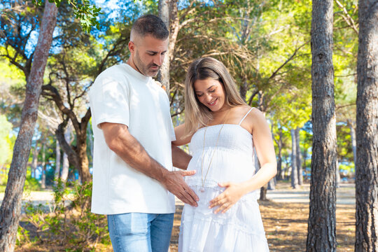 Peaceful woman relaxing with rainbow flag near marina at sunset in the city. Freedom, diversity, identity, equality and pride concept with urban background and soft golden light.