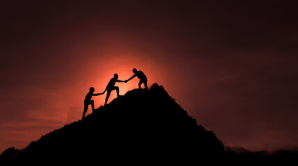 Silhouette of men climbing a mountain, helping each other to reach the summit, representing business teamwork and collaboration for success. People team work idea.