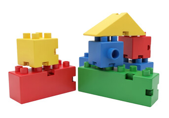 Isolated colorful plastic blocks toys on floor creating house structure for kids play