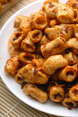 Indonesian-style fried macaroni tossed in a spicy seasoning blend, delivering a crunchy and flavorful snack.