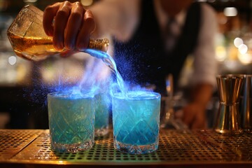 Experience the Thrill of Mixology with this Stunning Flaming Cocktail Creation at a Modern Bar, Perfect for Upscale Dining Promotions and Vibrant Nightlife Ads