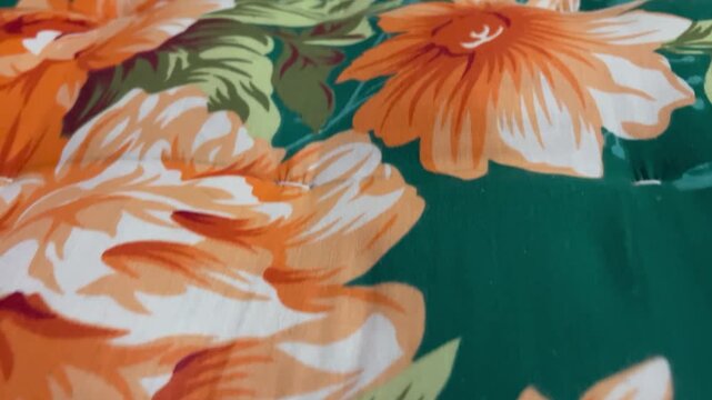 Floral pattern on a handmade mattress. The pattern consists of stylized orange flowers.