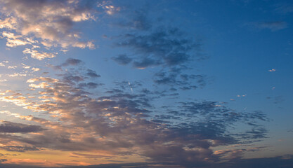 Enchanted evening sky filled with radiant sunset colors above drifting clouds