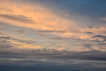 Majestic sunset sky shining brightly across delicate late afternoon clouds