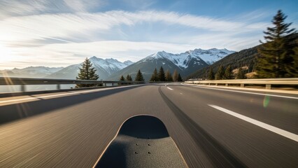 Experience freedom on a skateboard cruising down scenic mountain highway, feel the thrill and adventure with breathtaking snowy peaks, perfect for travel ads and active lifestyle content
