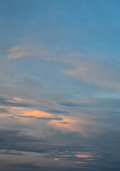 Serene late afternoon sky illuminated by warm sunset hues and light