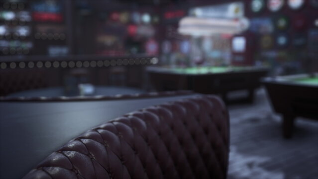 Inside a lively bar, plush seating lines the dark wood tables, and pool tables await eager players. Soft lighting creates a warm atmosphere for fun and socializing late into the night.