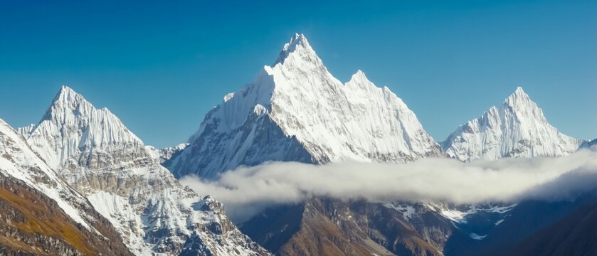 Snow-covered mountain peak under clear blue winter sky. - Powered by Adobe