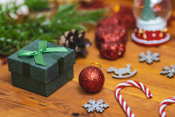 A green gift box among the Christmas decorations 