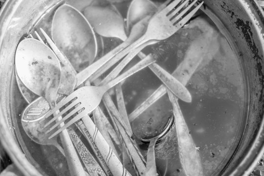 Black-and-White Dirty Dishes in Water