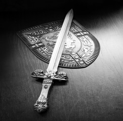 Fototapeta premium Iron shield and sword on the table