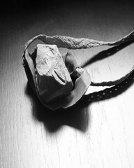 Sling with stone on wooden background