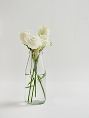 Elegant White Roses in Clear Water Vase