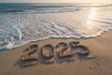 Sand beach with waves gently lapping at shore, displaying the year 2025 written in the sand, capturing the essence of new beginnings and fresh starts