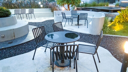 Iron tables and chairs with a modern minimalist design outside a cafe