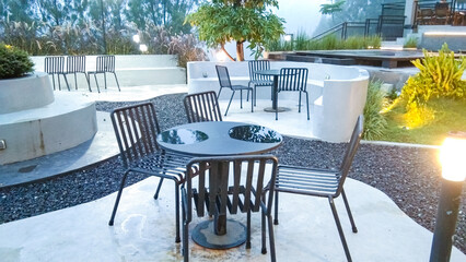Iron tables and chairs with a modern minimalist design outside a cafe