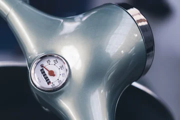 Selbstklebende Fototapeten Roller Close up of silver vintage scooter handlebar with speedometer  © macondos