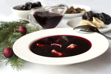 Christmas beetroot soup (borscht) with dumplings, mushrooms and dried plums
