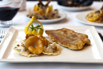 Christmas fried fish in breadcrumbs with chanterelle mushrooms and dumplings