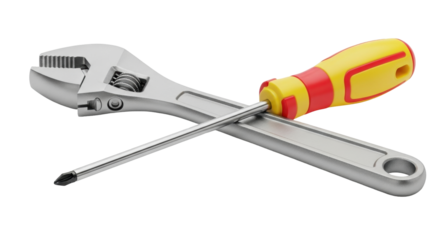 Isolated adjustable wrench and screwdriver laying crossed atop each other on a surface