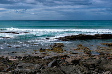 View of surf crashing against the rocks and the Victorian coastline along the Great Ocean Road, Australia.